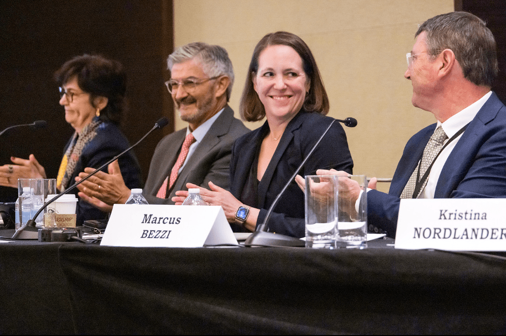 A panel of four speakers